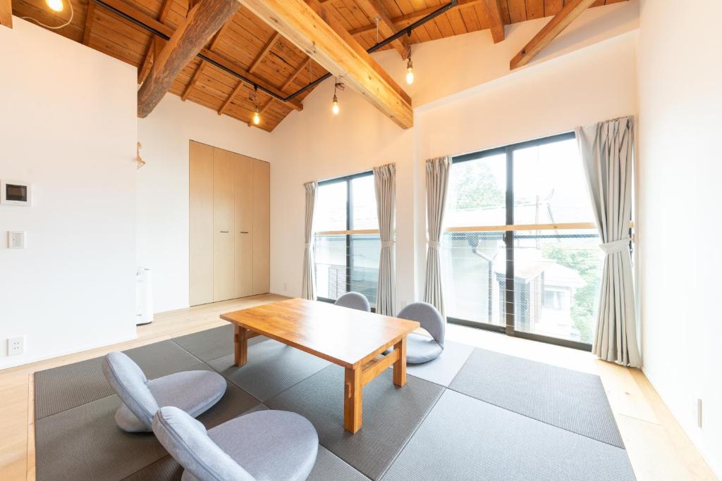 a dining room with a wooden table and chairs at 強羅base A棟 - GORA Base A in Gora