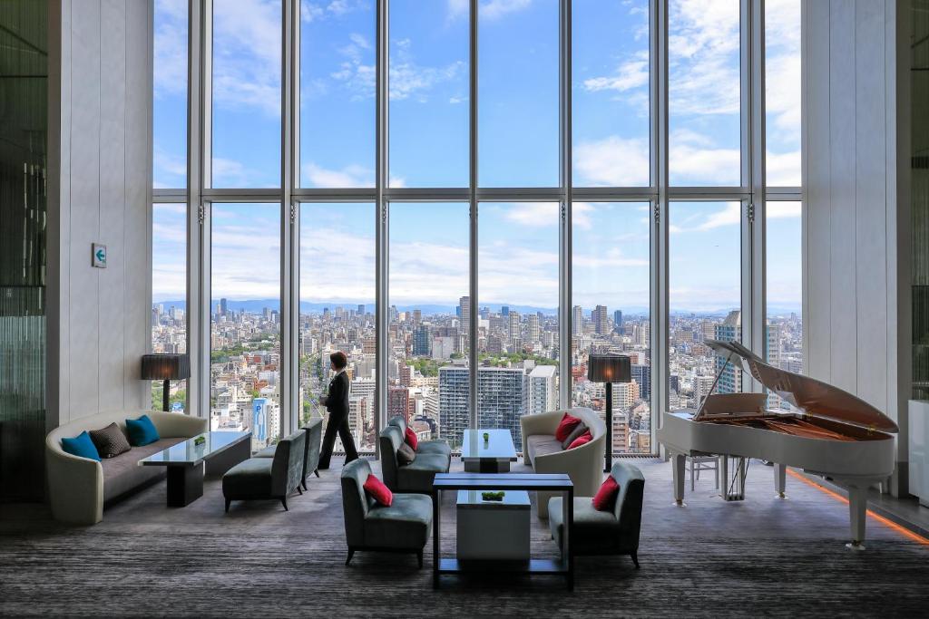 a person standing in a room with a large window at Osaka Marriott Miyako Hotel in Osaka