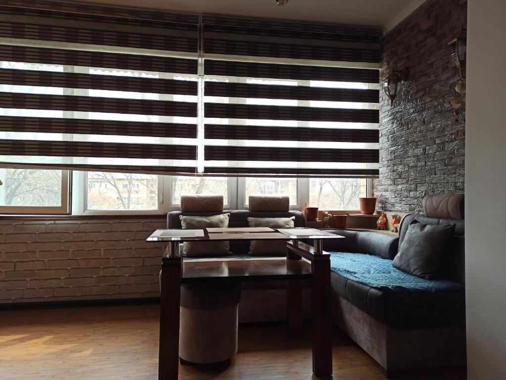 a living room with a couch and a table at Sweet Home in Tashkent
