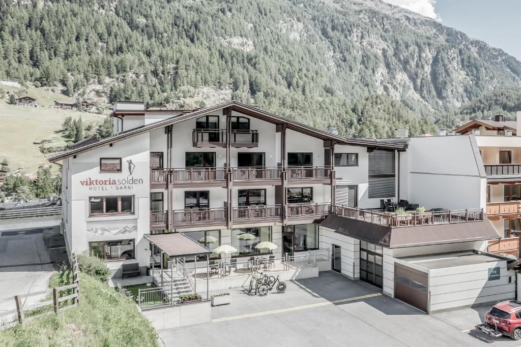 an aerial view of a hotel with a mountain in the background at Viktoria Sölden in Sölden