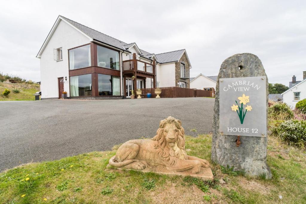 a statue of a woman sitting in front of a house at Cambrian View in Aberystwyth