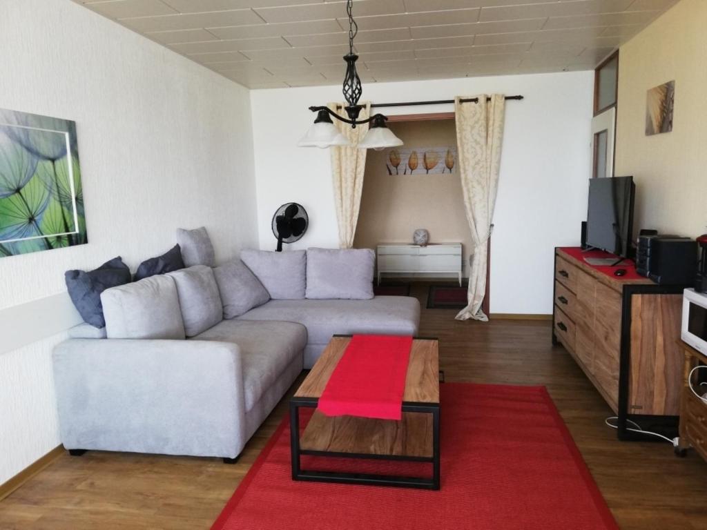 a living room with a couch and a coffee table at Fewo " fáros " in Heiligenhafen
