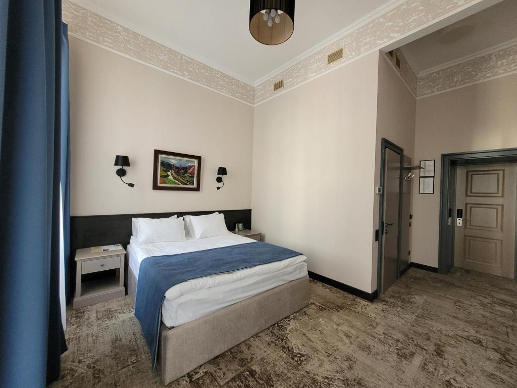 Postel nebo postele na pokoji v ubytování Ayvazovsky Hotel