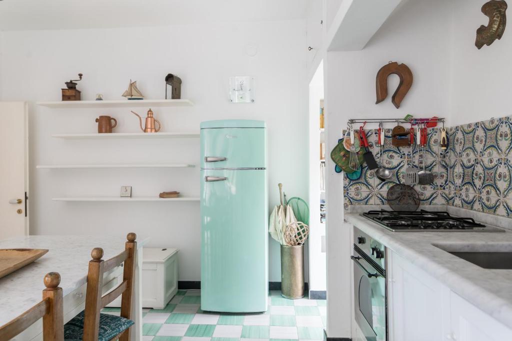 a kitchen with a blue refrigerator in a room at Villa Smith in Vernazza