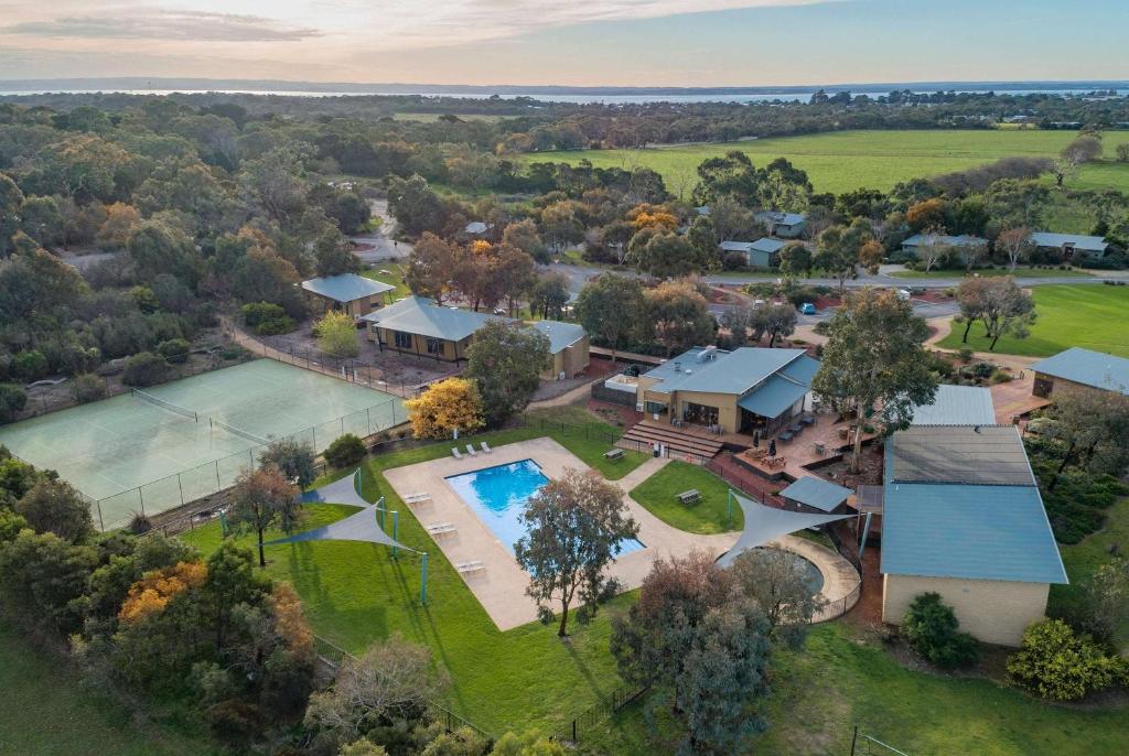 an aerial view of a home with a pool and a house at Ramada Resort by Wyndham Phillip Island in Cowes