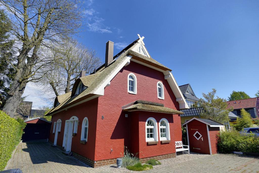 a small red house with a roof at Carolin in Zingst