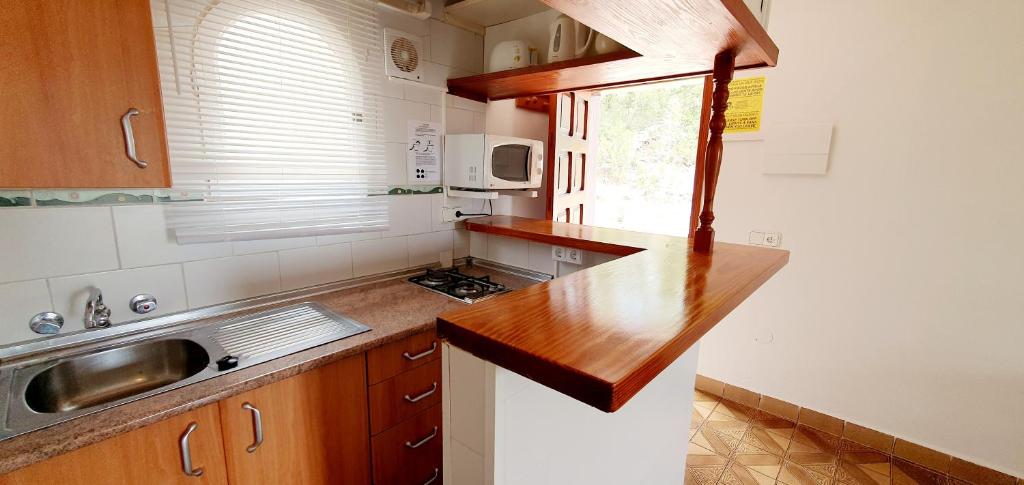 a kitchen with a counter top and a sink at Granada Apartments Familiar Deluxe in Portinatx