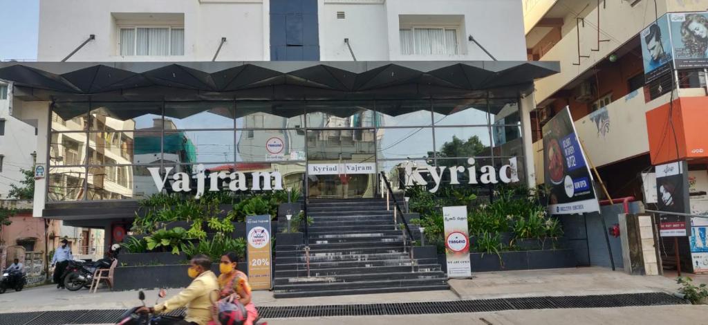 a building with stairs in the middle of a street at Kyriad Vajram Guntur in Guntūr
