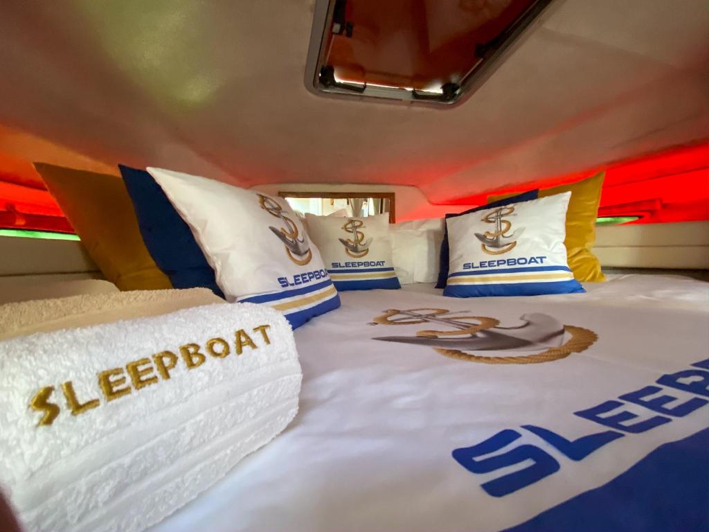 a bedroom with a bed with baseball pillows on it at SLEEPBOAT YACHT in Porto
