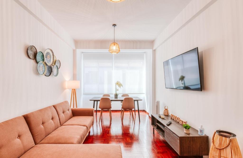 a living room with a couch and a table at The Millennial Lifestyle Apartment in Funchal