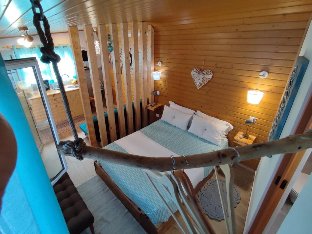 a bedroom with a bed in a wooden cabin at Casa do Mar - Nazaré in Nazaré