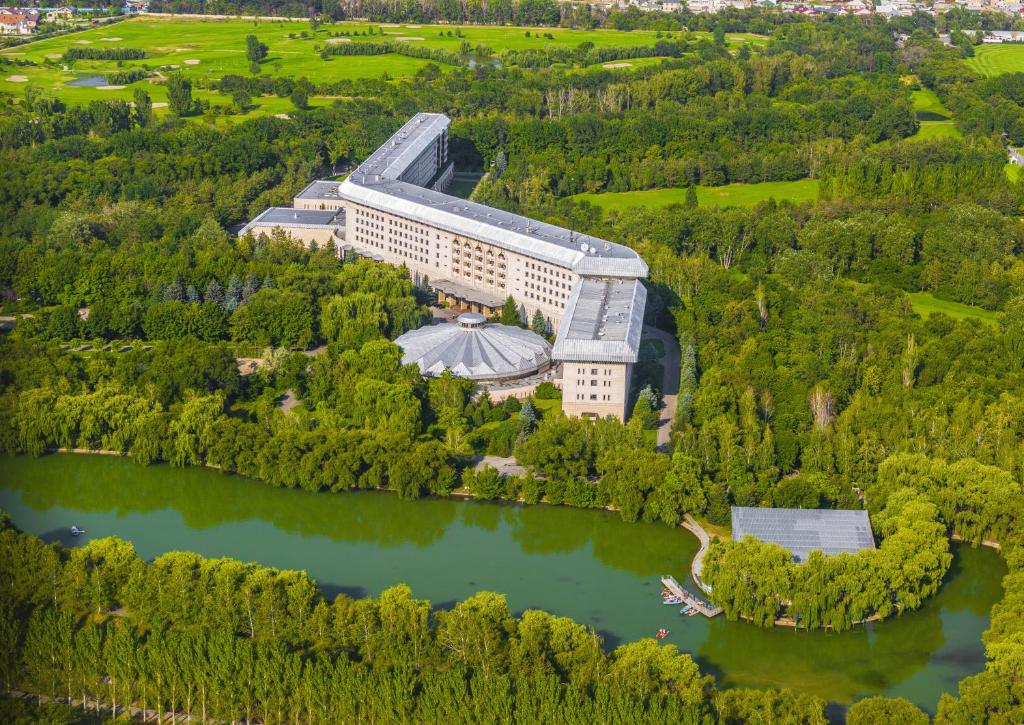 an aerial view of a building next to a lake at Swissôtel Wellness Resort Alatau Almaty in Almaty