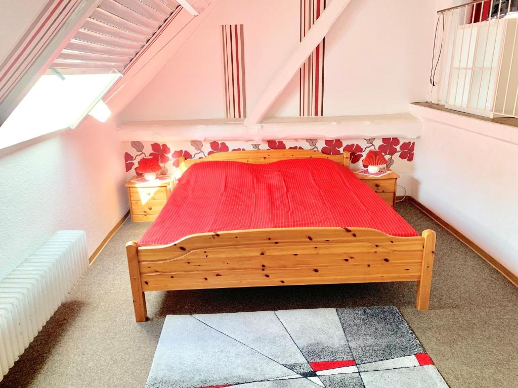 a bedroom with a wooden bed in a attic at Ferienhof Frohne - Up de Hielen in Merzen