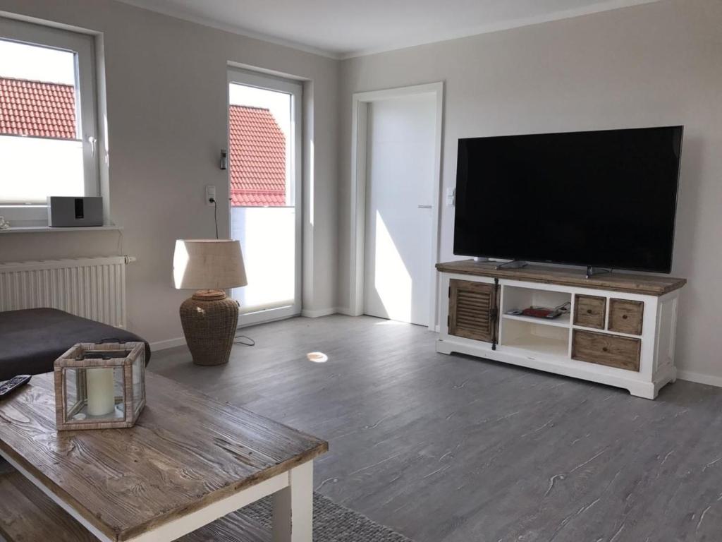 a living room with a flat screen tv on a entertainment center at Schleiglück in Rieseby