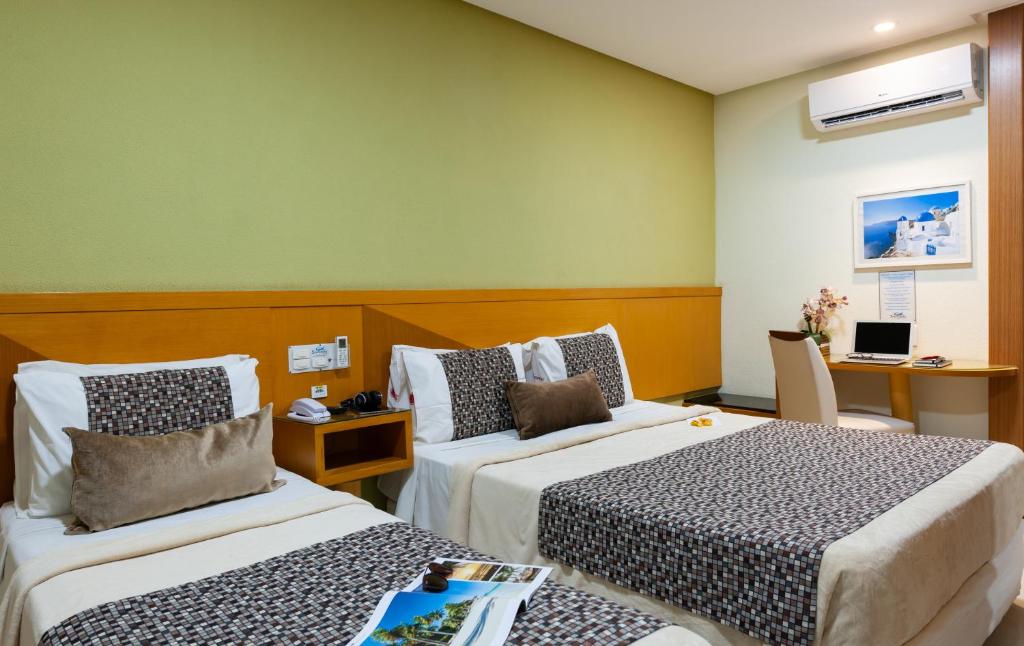 Postel nebo postele na pokoji v ubytování Hotel Santorini