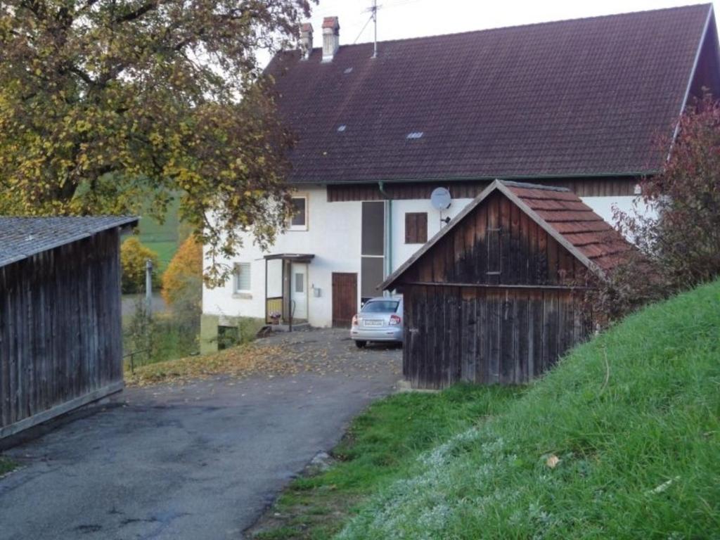 a house with a car parked next to a driveway at OG Stetten 