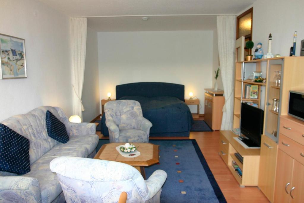 a living room with two couches and a tv at Plass, FP I-5-3 in Heiligenhafen