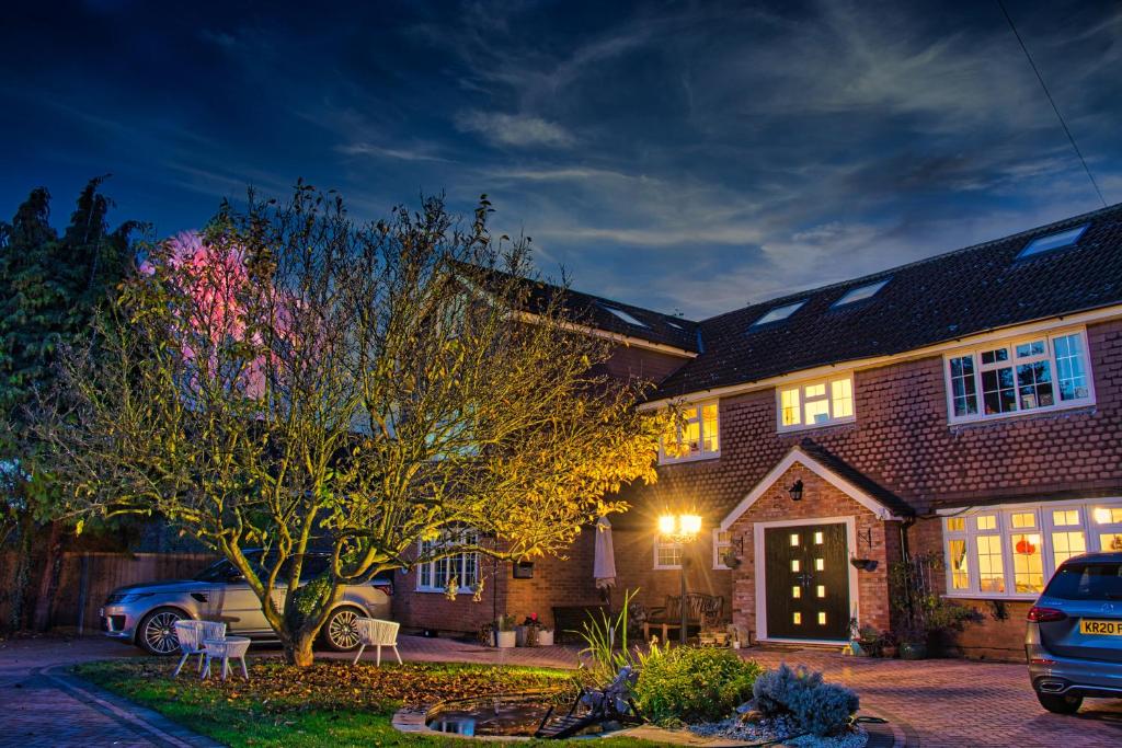 a house with a car parked in front of it at Orchard Cottage 