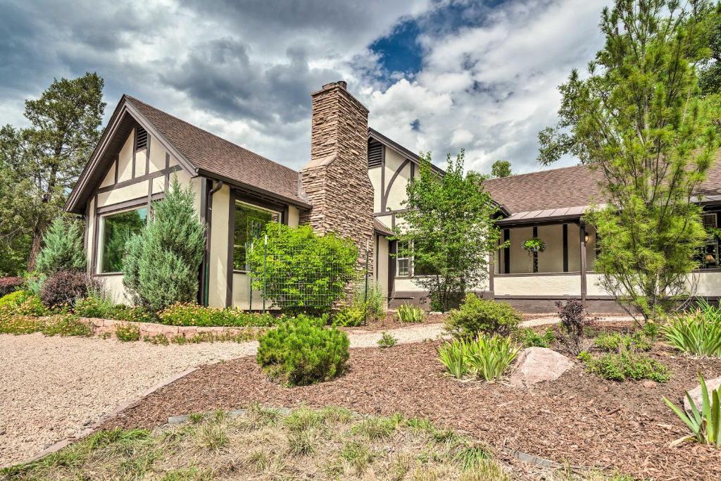 a house with a brick chimney on top of it at Spacious Manitou Home with Views in Central Location in Manitou Springs