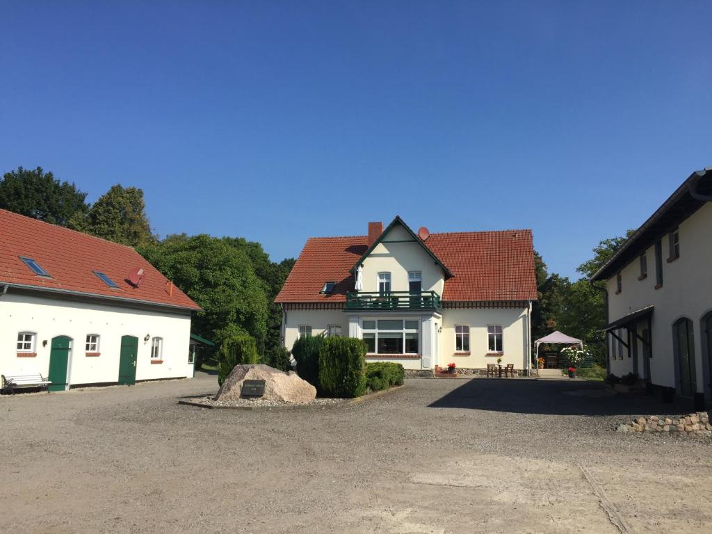 a large white house with a red roof at Blauer Salon in Satow