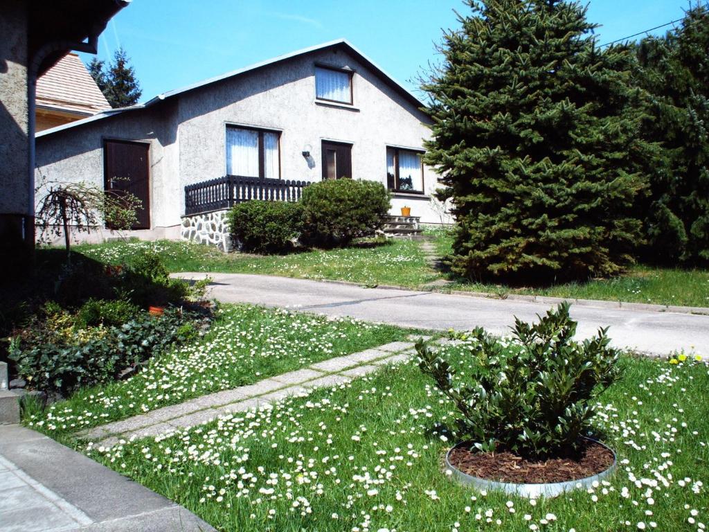 a house with white flowers in the yard at Ferienhaus Köllner in Fischbach