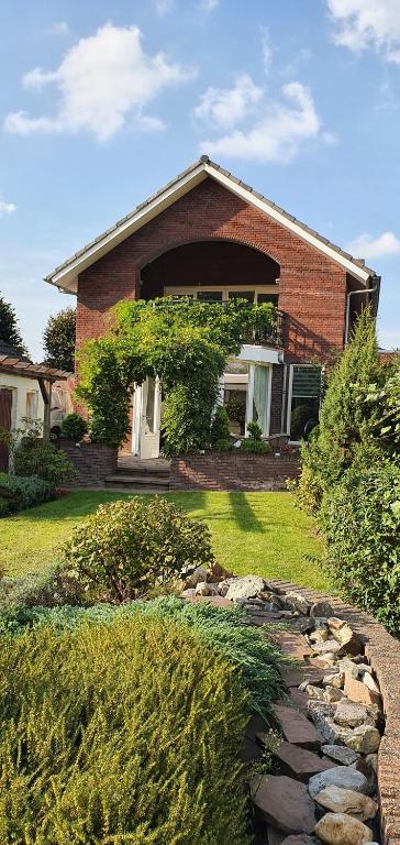 a brick house with a stone path in front of it at de Kempenvallei in Luyksgestel