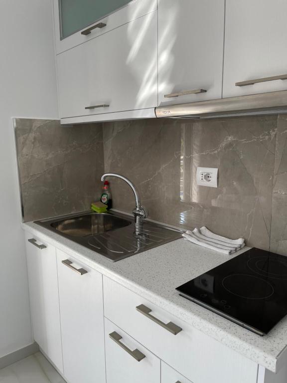 a kitchen with a sink and a counter top at Villa Angelina Ksamil in Ksamil