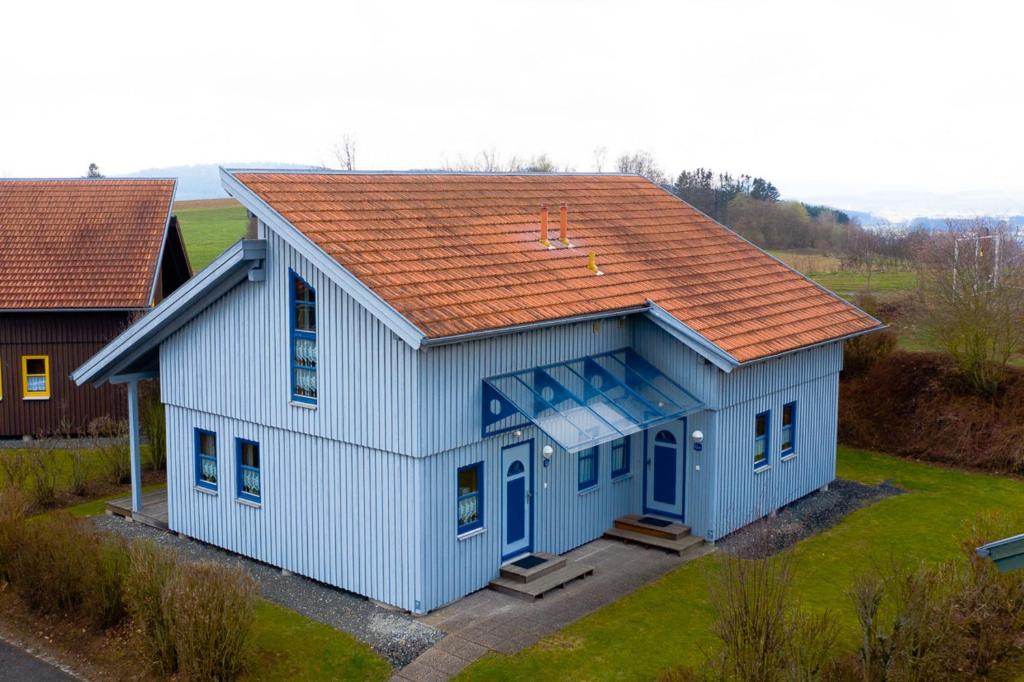 an overhead view of a blue house with an orange roof at Ferienhaus Nr 12B1, Feriendorf Hagbügerl, Bayr Wald in Waldmünchen