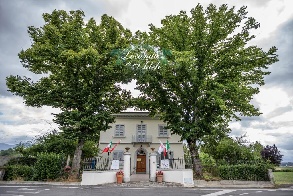 a building with two trees in front of it at La Locanda di Adele - Il Giardinetto B&B in Scarperia