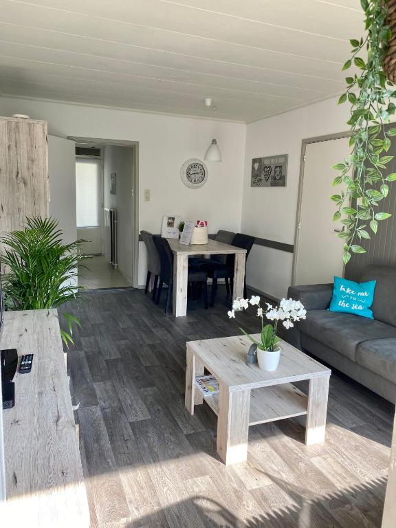 a living room with a couch and a table at Appartement Dishoek in Koudekerke