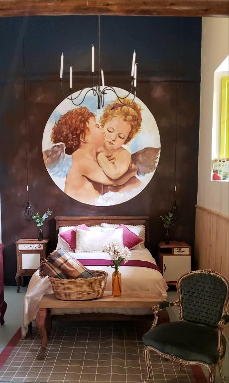 a bedroom with a painting of a woman holding a baby at Niños Hotel Fierro in Cusco