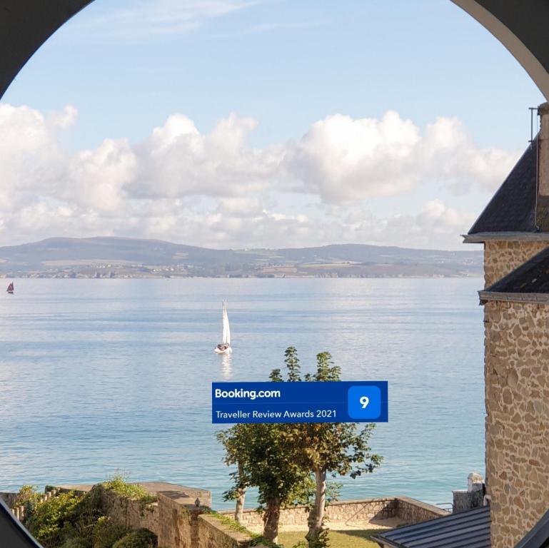 a view of a lake with a boat in the water at Le charmant des Sables Blancs in Douarnenez