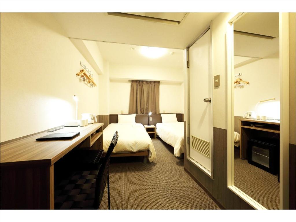 מיטה או מיטות בחדר ב-Sendai Business Hotel Ekimae - Vacation STAY 71920v