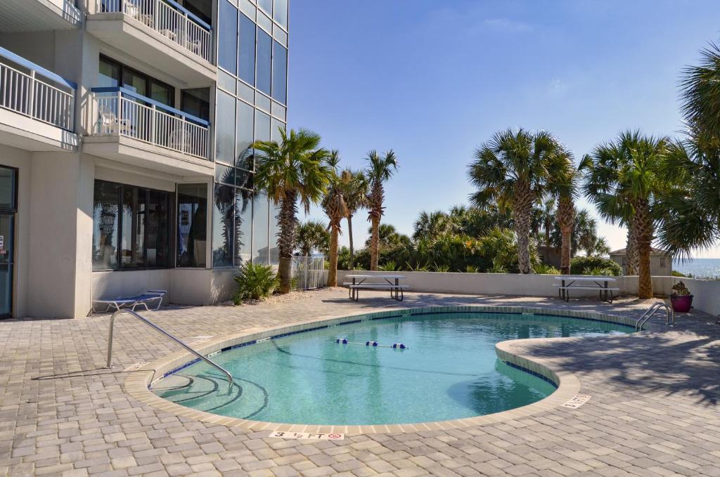 een zwembad voor een gebouw met palmbomen bij Forest Dunes Resort in Myrtle Beach