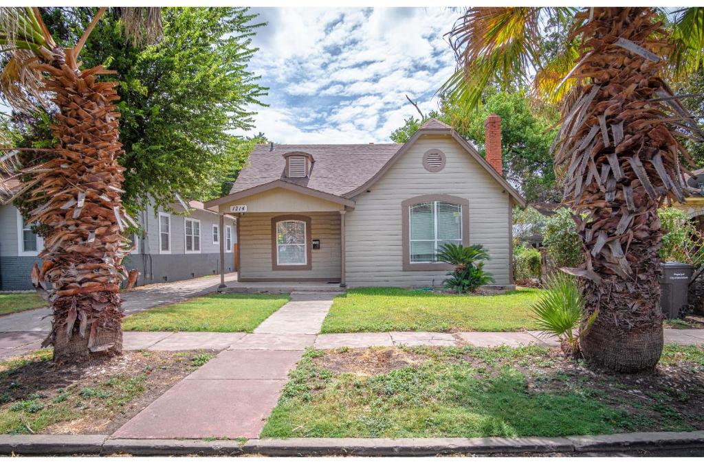 a house with two palm trees in front of it at Florida St Nice Remodeled 3BR/2BA Near Downtown in San Antonio