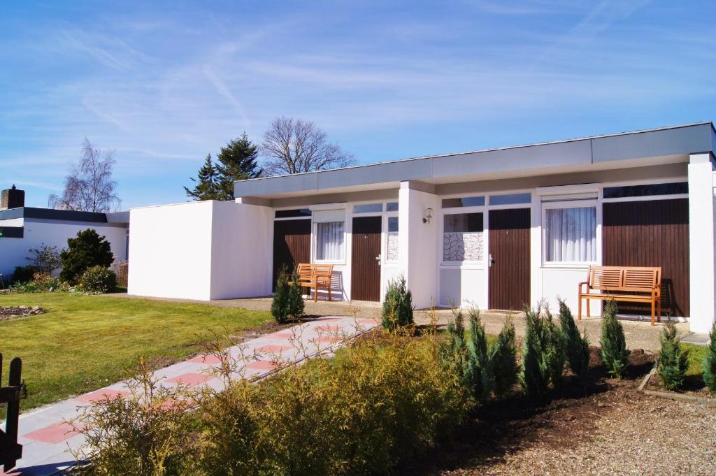 a small white house with a porch at An der Allee 20 B in Dahme