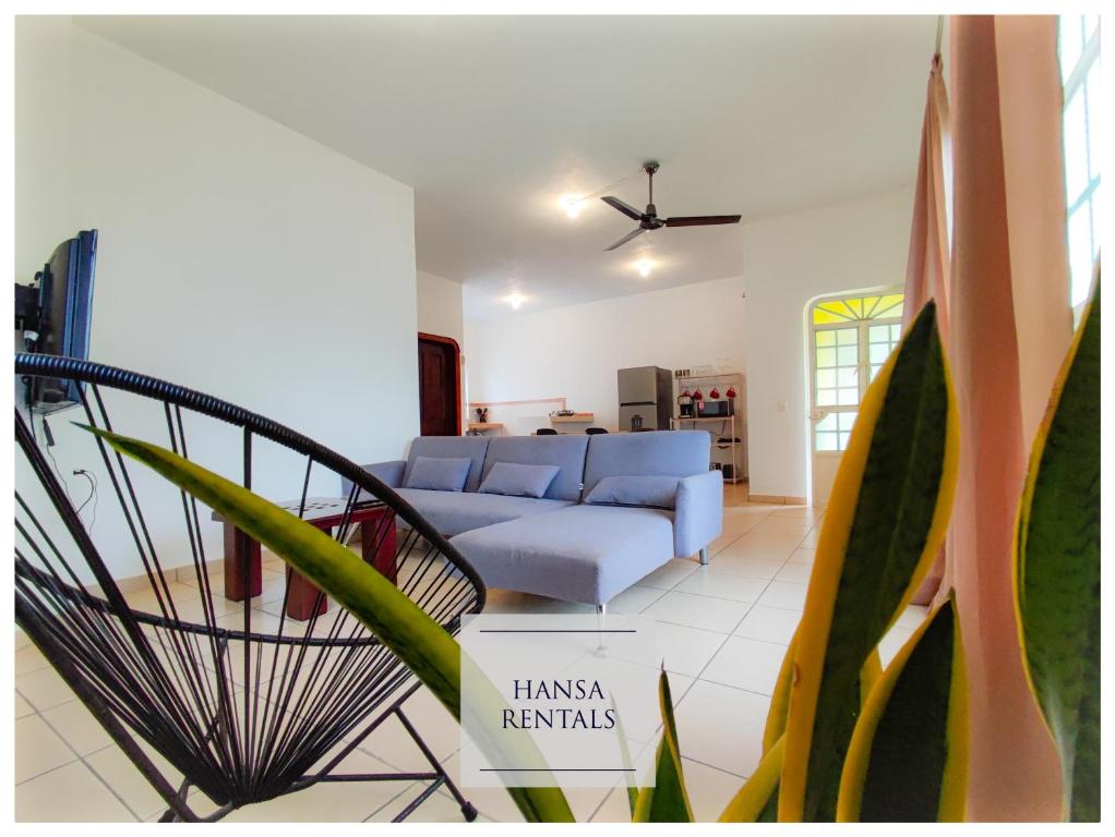 a living room with a blue couch at Hansa Departameto in Puerto Vallarta