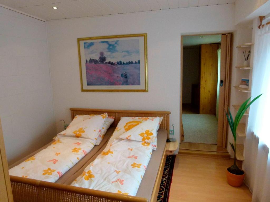 a bedroom with two beds and a painting on the wall at Ferienwohnung Max 1 in Grube