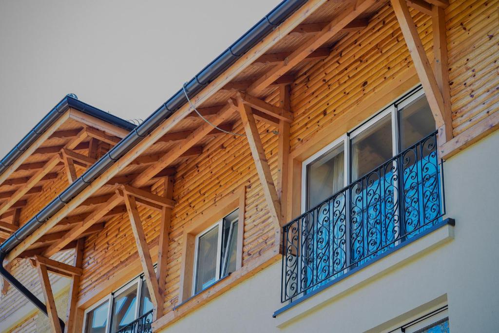 a balcony on a house with a wooden roof at Apartments Bramar in Zlatibor