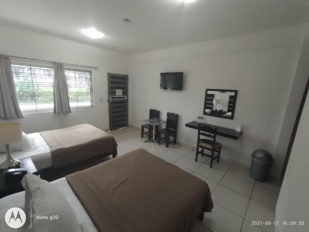Postel nebo postele na pokoji v ubytování Hotel & Suites Mo Sak