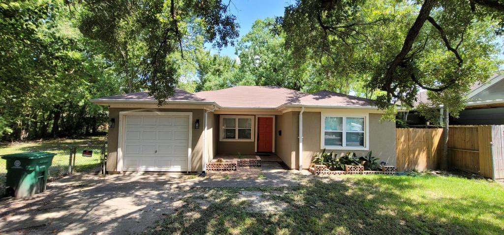 a small house with a red door at Rebecca Street House - Close to Med Center, Downtown, NRG in Houston