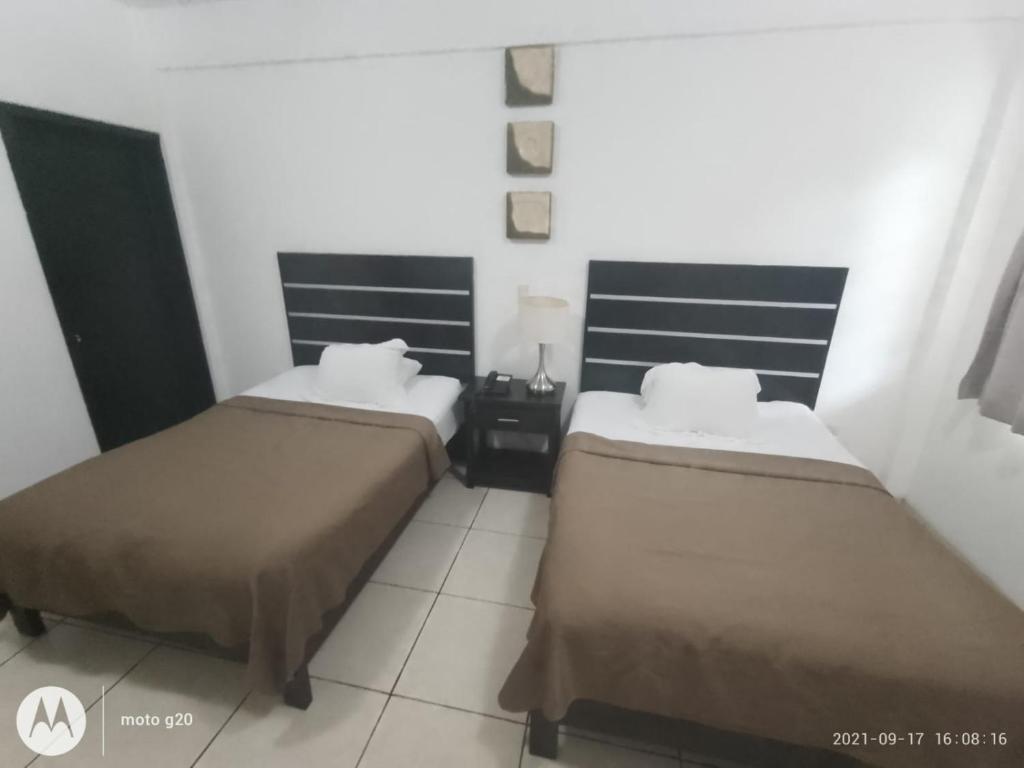 Postel nebo postele na pokoji v ubytování Hotel & Suites Mo Sak