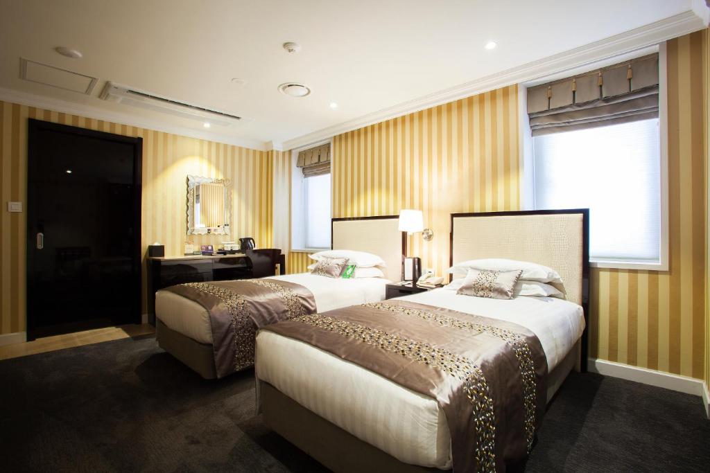 Postel nebo postele na pokoji v ubytování The Grand Hotel Myeongdong