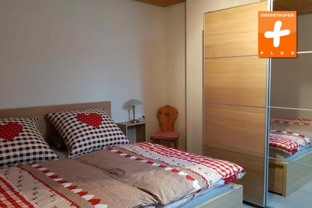 a bedroom with a bed and a dresser at Appartement Nr 11, Fewo in Oberstaufen-Steibis in Oberstaufen