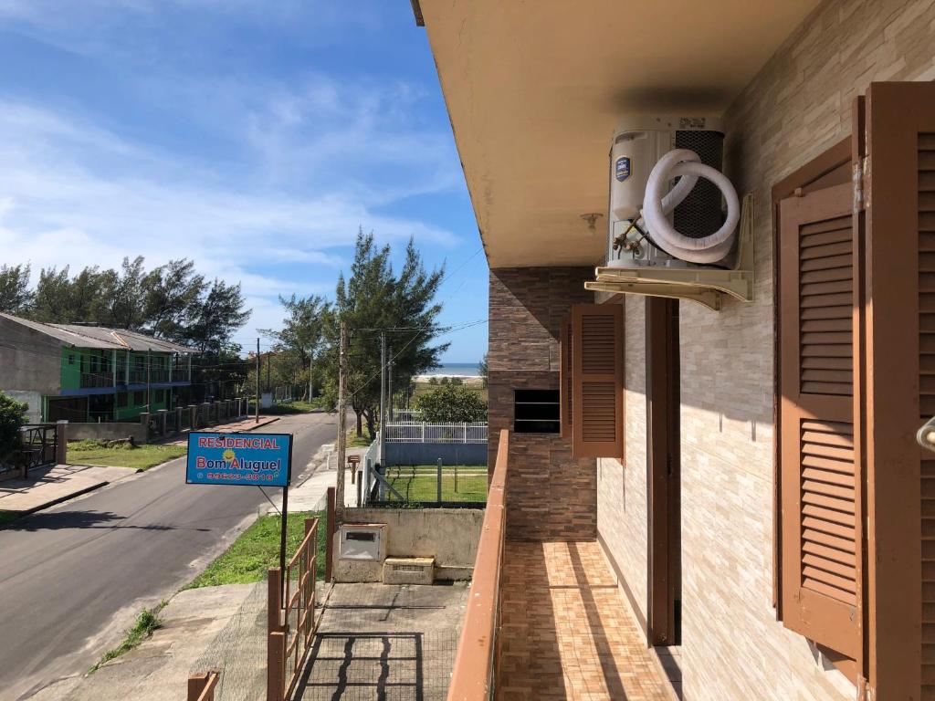a building with a air conditioner on the side of a street at Residencial BomAluguel in Capão da Canoa