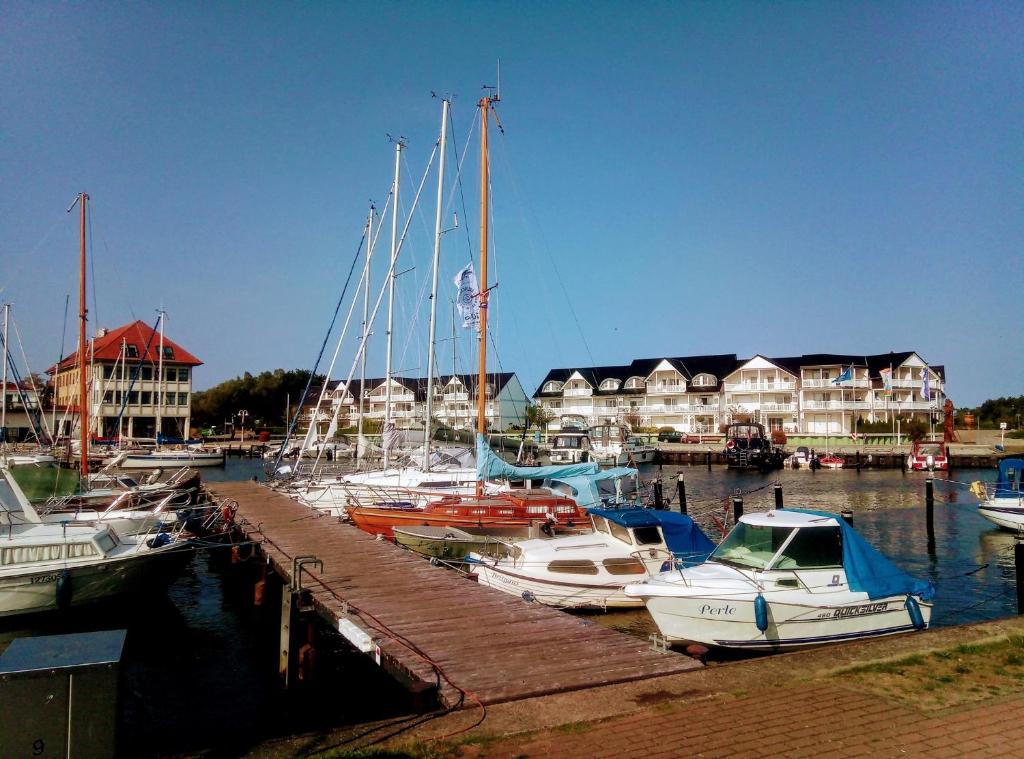 a bunch of boats docked in a marina with houses at Hafenkiek 39 in Ostseebad Karlshagen
