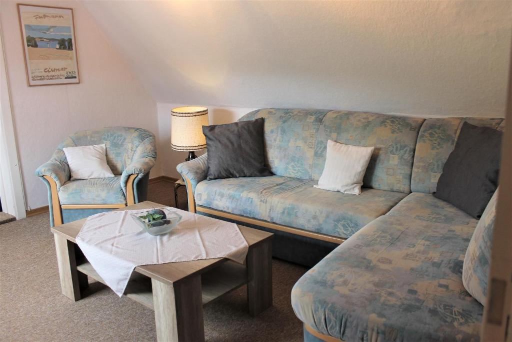 a living room with a couch and a table at Haus Uschi - Ferienwohnung in Cismar