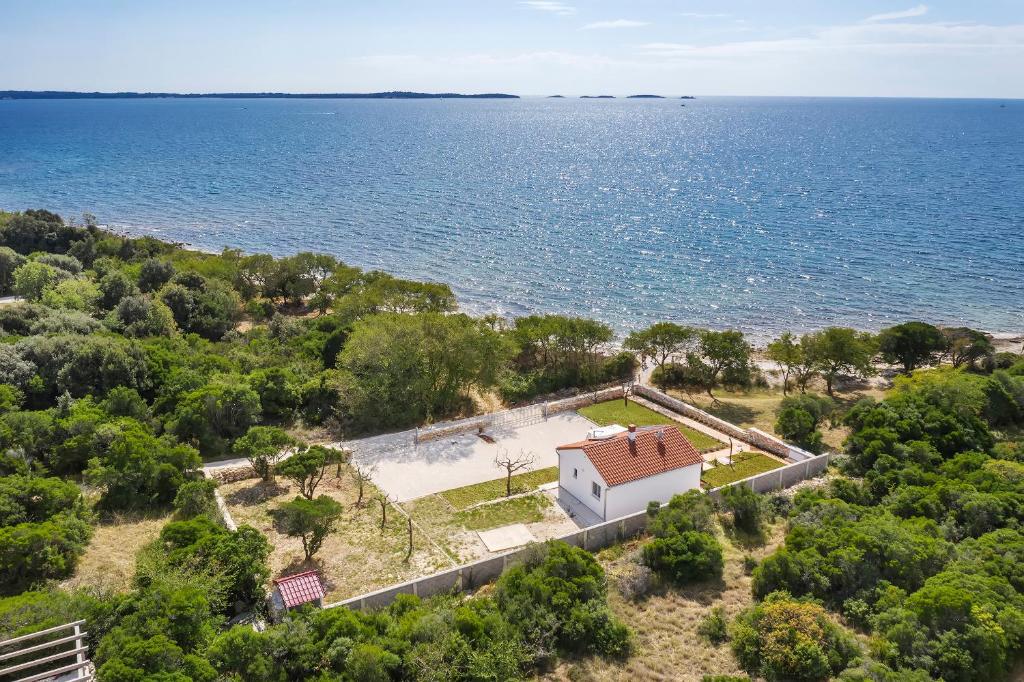 an aerial view of a house next to the ocean at House of peace in Peroj