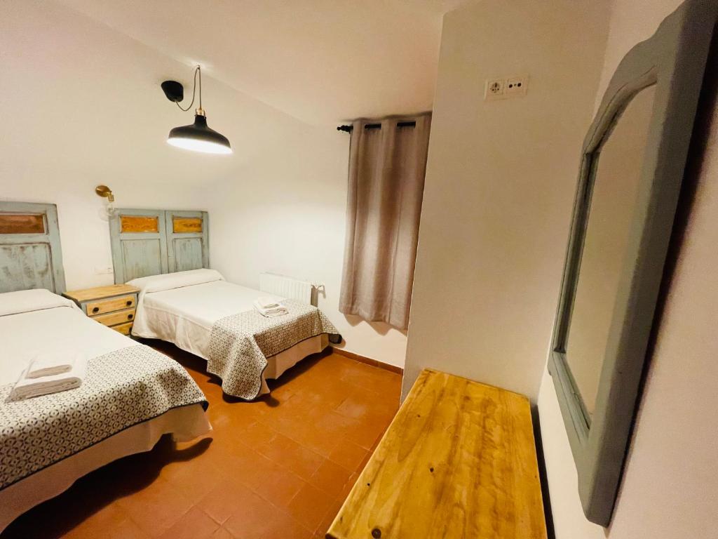 Postel nebo postele na pokoji v ubytování Albergue Hospedería Montaña Morciguillinas