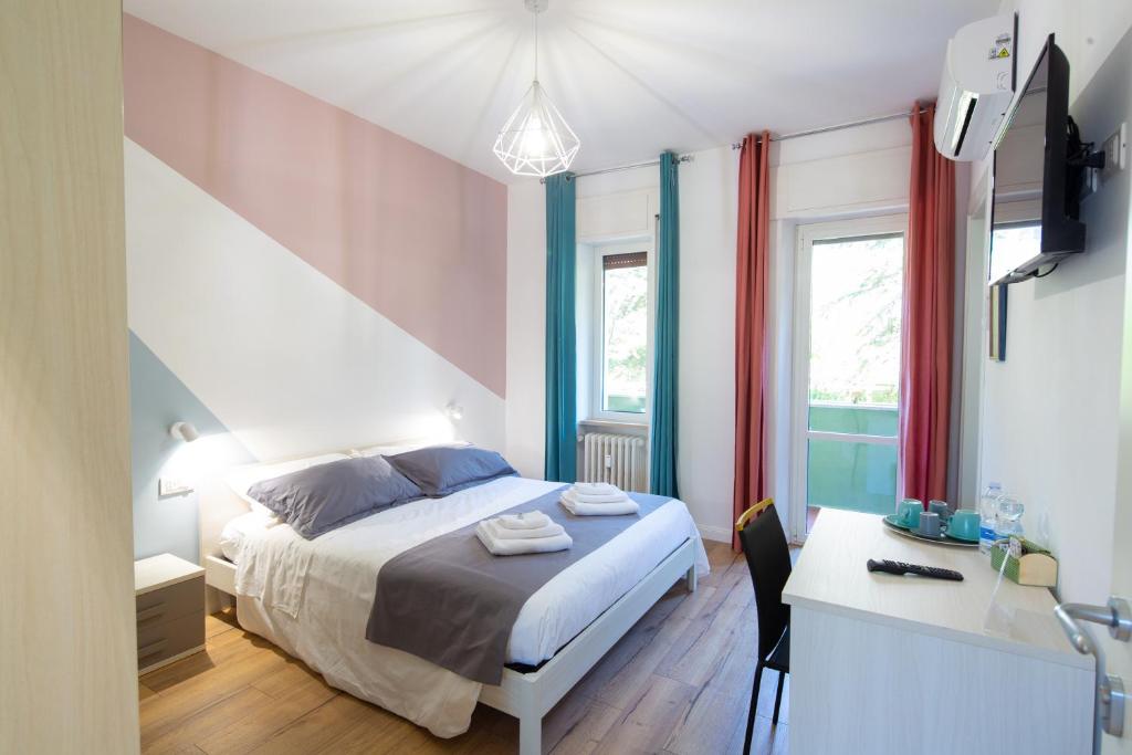 a bedroom with a bed and a desk and window at CASA STELLA San Sisto in Perugia